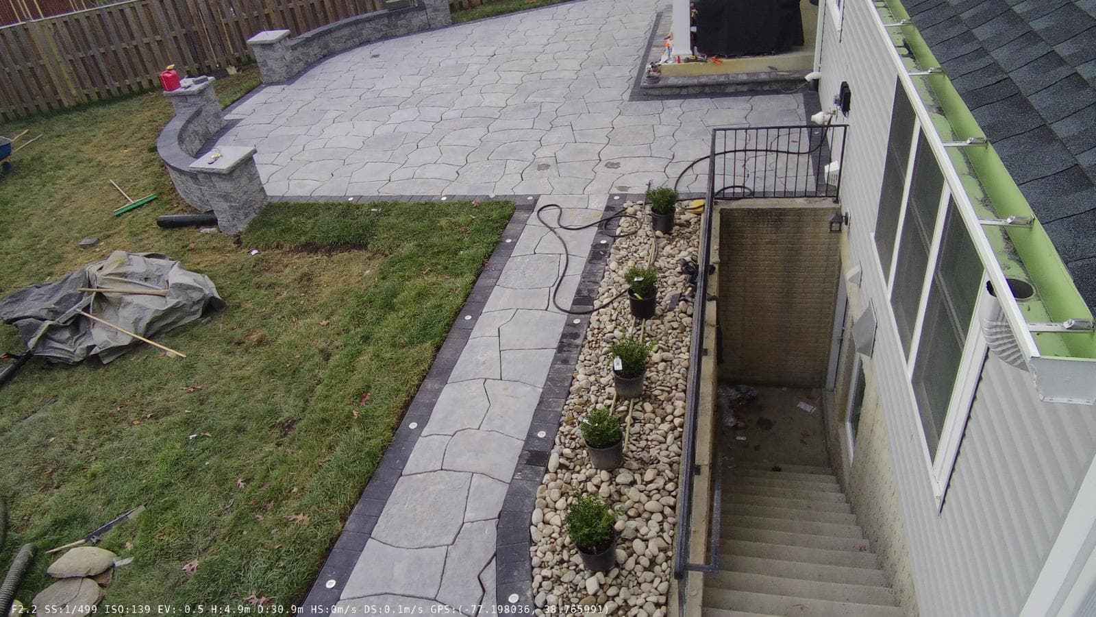 Aerial drone view of completed paver patio with dry creek bed