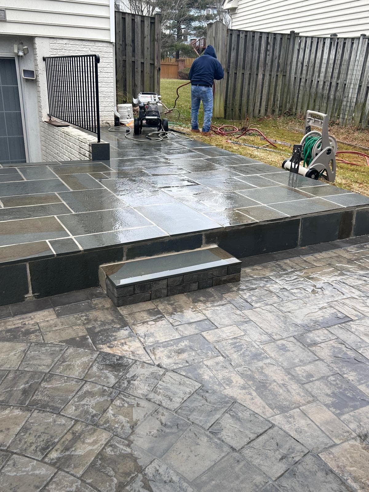 Paver patio in progress being pressure washed by Kaeler crew