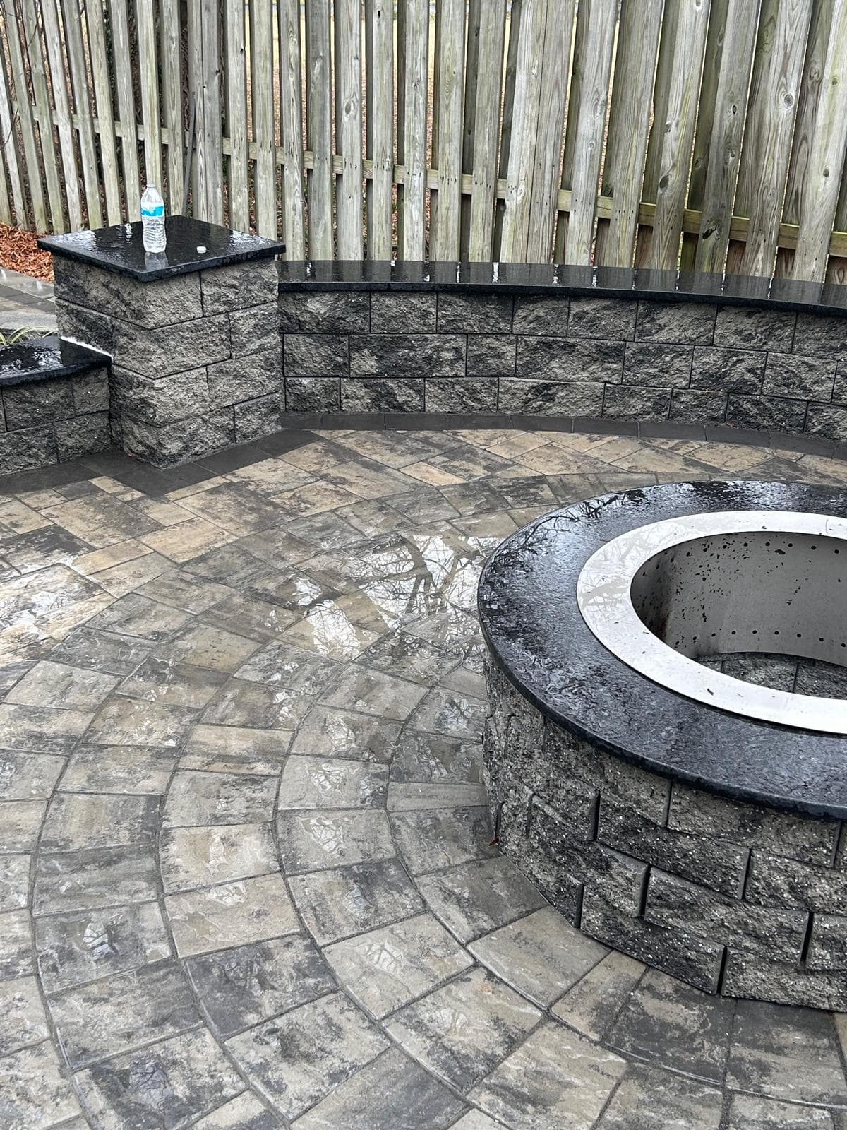 Circular fire pit with paver patio and seating walls