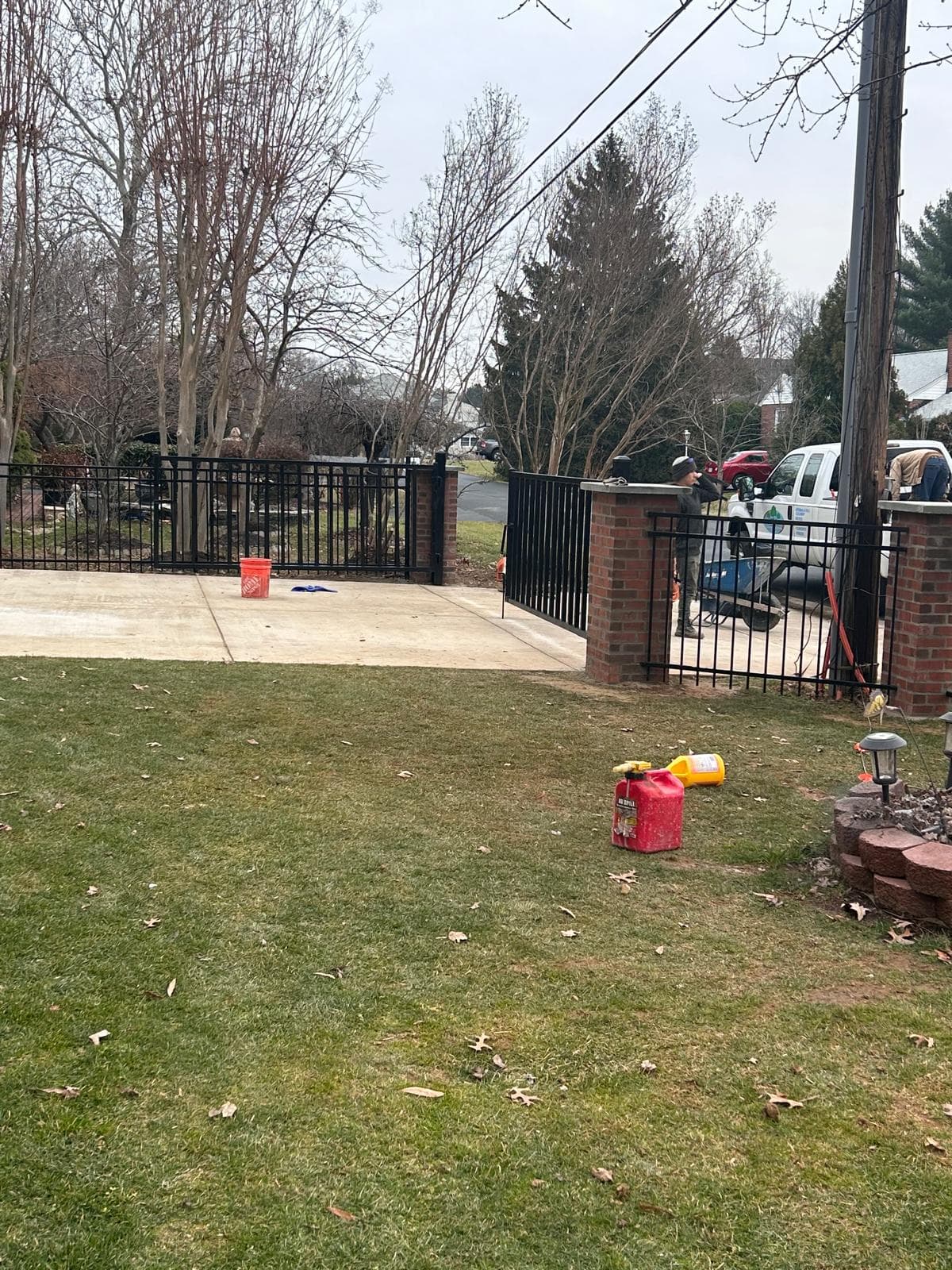Iron fence with lawn and driveway