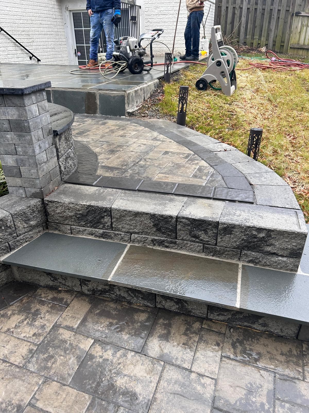 Paver steps with crew working in the background