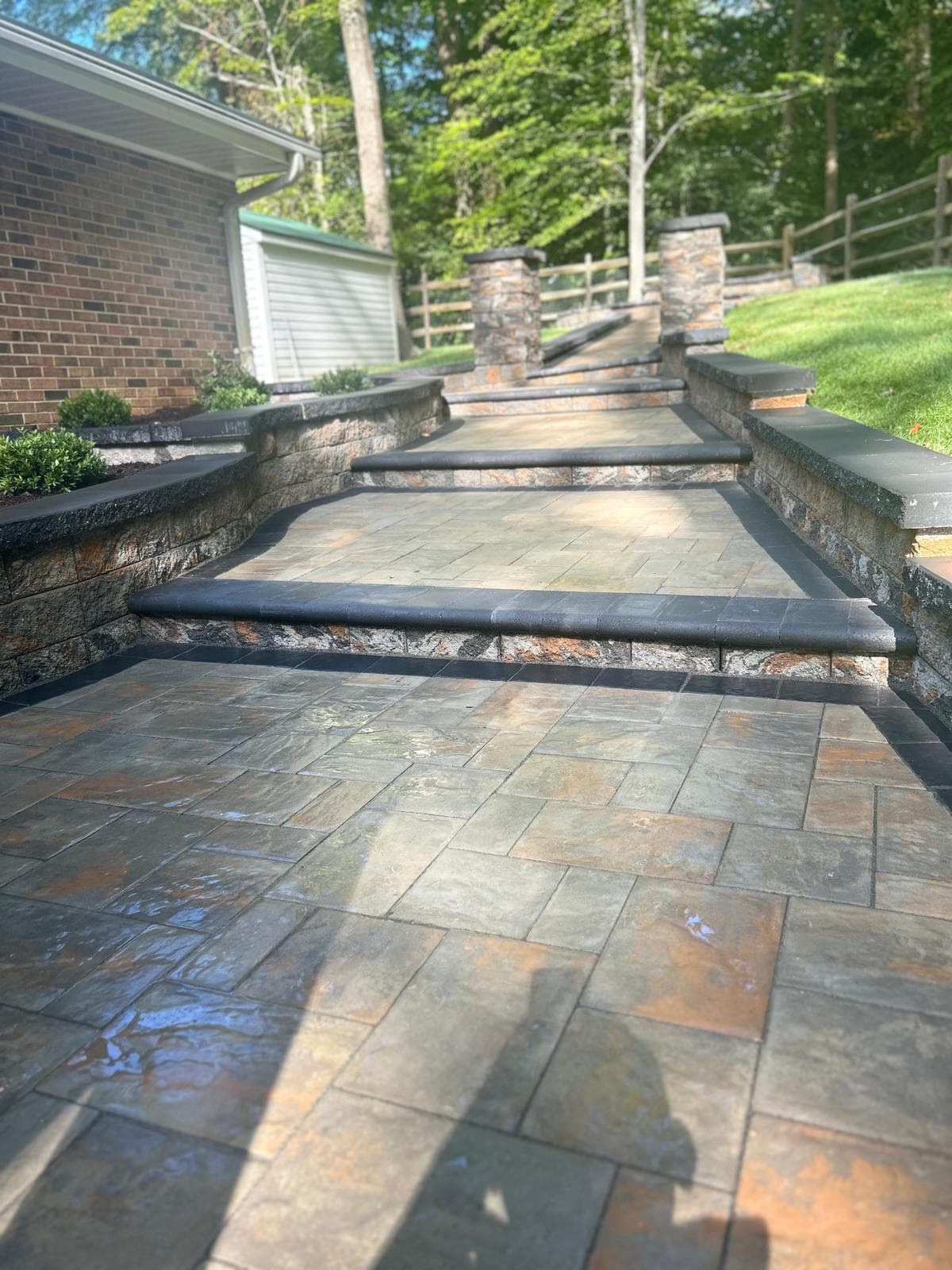 Walkway, retaining wall and stone pillars by Kaeler