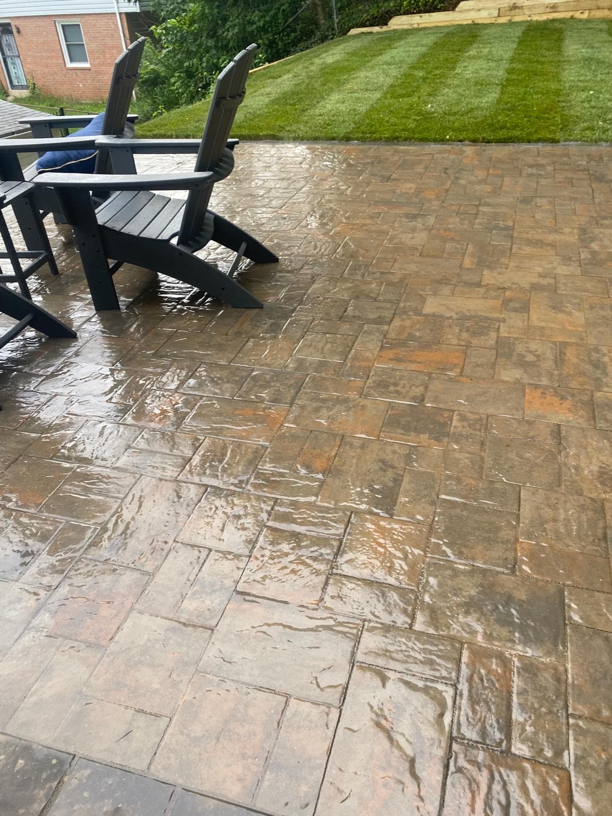 Stamped concrete patio with adirondack chairs