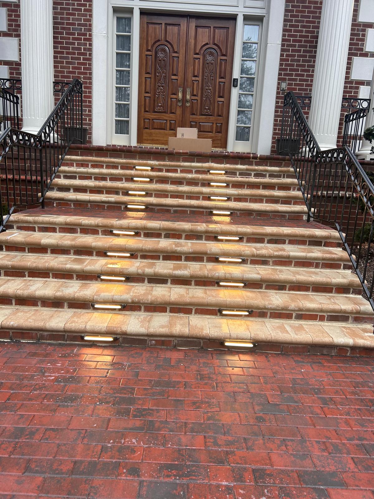 Brick front steps with riser lighting on a cold winter day by Kaeler